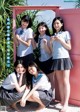 A group of young women in school uniforms posing for a picture.