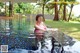 A woman in a pink bikini sitting in a pool.