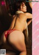 a japanese woman in a red thong is posing for the camera