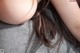 A close up of a woman's breasts on a couch.