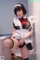 A woman in a maid outfit is posing for the camera.