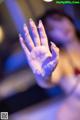 A woman's hand covered in water at a party.